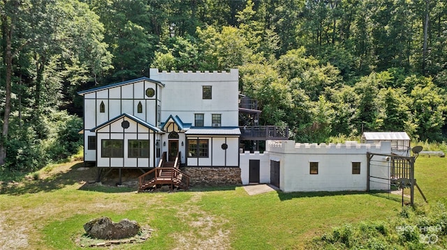 rear view of house with a lawn and a sunroom