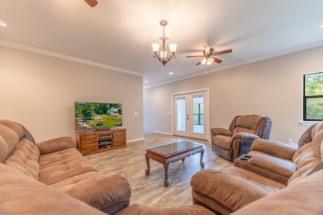 living room with light wood-type flooring, french doors, ceiling fan with notable chandelier, and ornamental molding