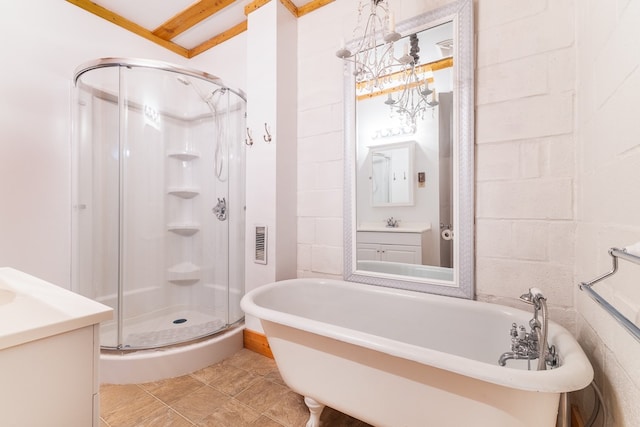 bathroom featuring plus walk in shower, tile walls, tile flooring, vanity with extensive cabinet space, and crown molding