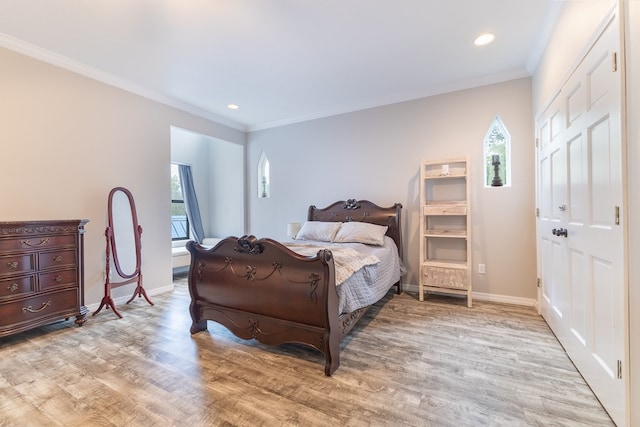 bedroom with light wood-type flooring and crown molding