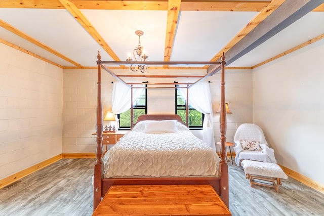 bedroom featuring a notable chandelier, beam ceiling, and wood-type flooring