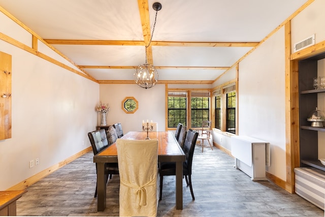 dining room featuring a notable chandelier, vaulted ceiling with beams, and light hardwood / wood-style flooring