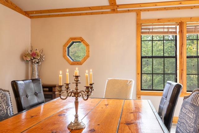 dining space with beam ceiling