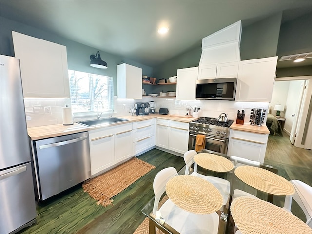 kitchen featuring backsplash, white cabinetry, appliances with stainless steel finishes, and sink