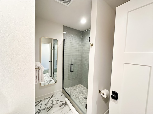 bathroom with tile floors and a shower with shower door