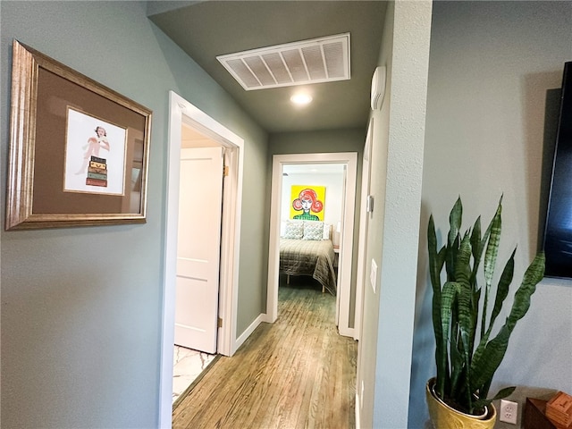 corridor with light hardwood / wood-style floors