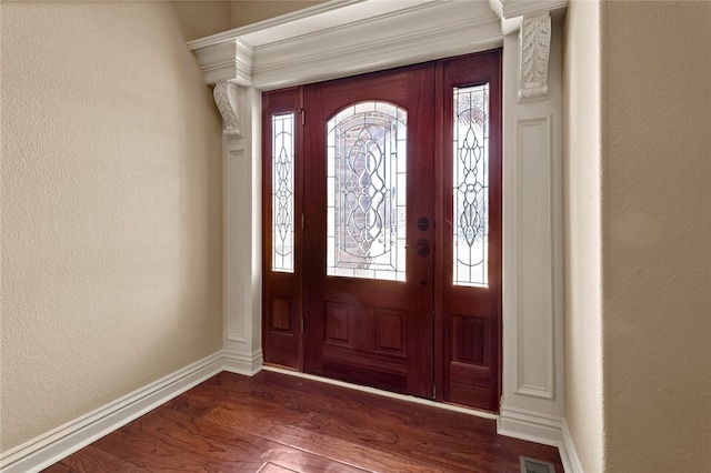 entryway with crown molding, dark hardwood / wood-style flooring, and a healthy amount of sunlight