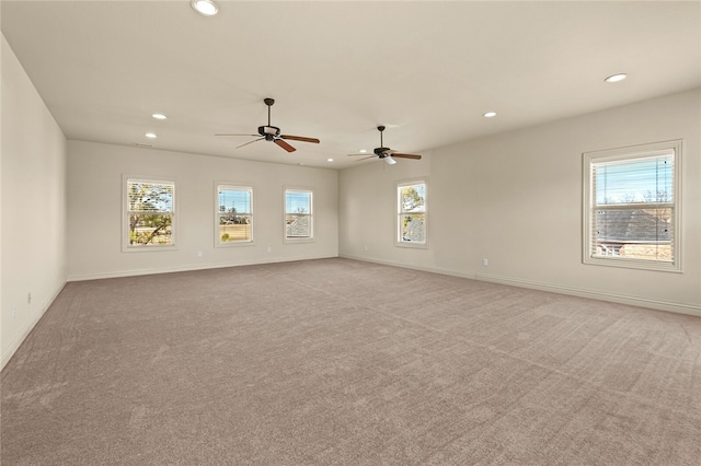 spare room with light colored carpet and ceiling fan