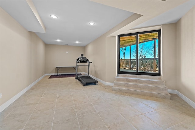 workout room featuring light tile flooring