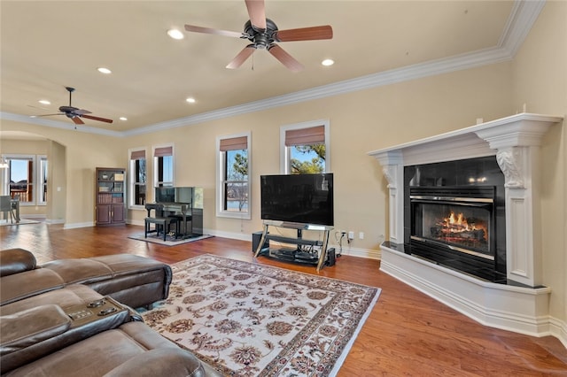 living room with dark hardwood / wood-style floors, ceiling fan, and a wealth of natural light