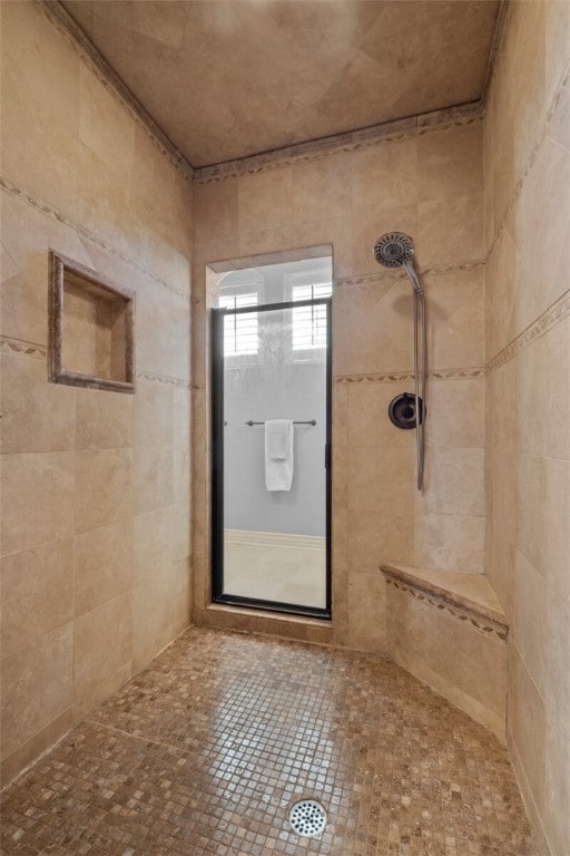 bathroom featuring a tile shower