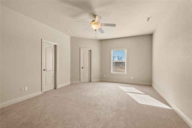 unfurnished bedroom featuring ceiling fan and light colored carpet