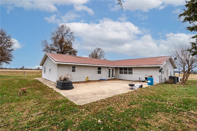 rear view of house featuring a yard and a patio