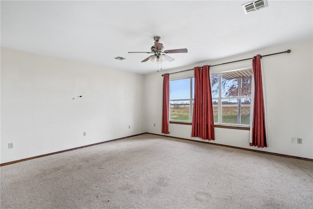 carpeted spare room with ceiling fan