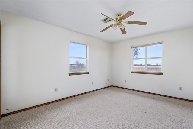 carpeted spare room with ceiling fan