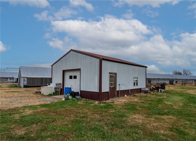 view of outbuilding with a yard and a garage