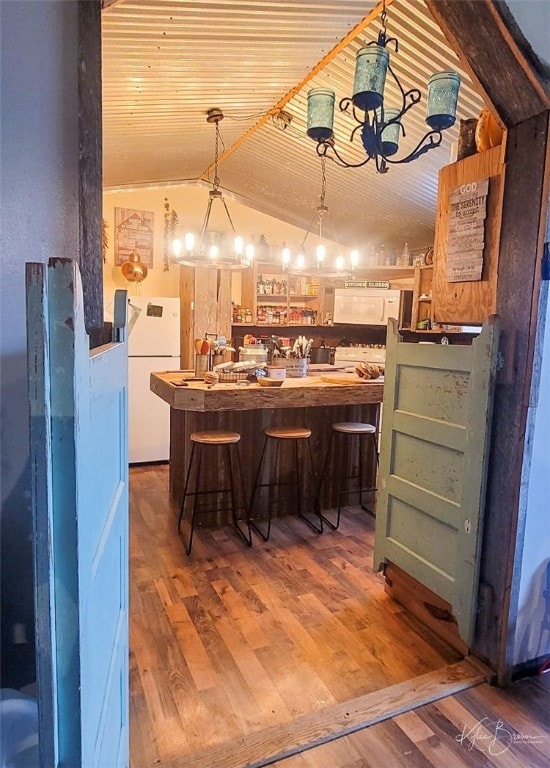 bar with light wood-type flooring, vaulted ceiling, wooden ceiling, and white fridge