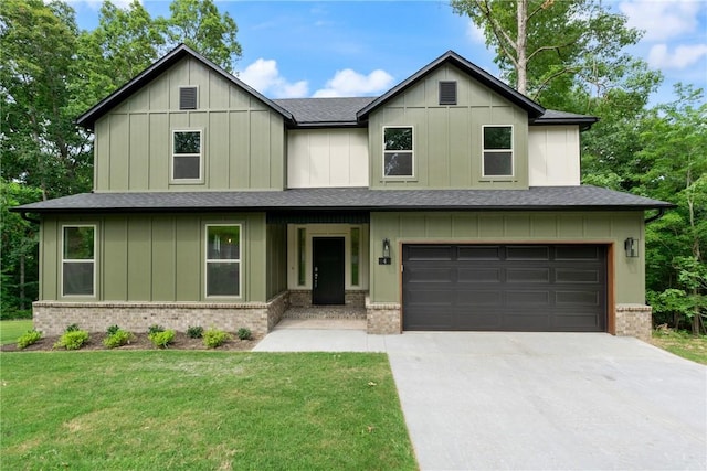 view of front of property with a front lawn and a garage