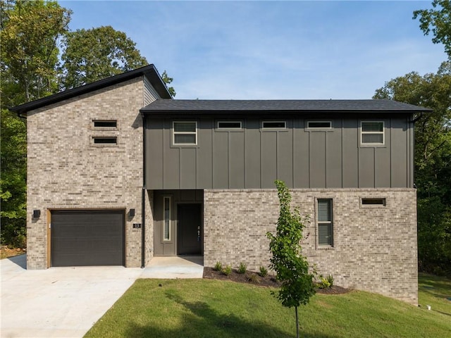 view of front of home featuring a garage, concrete driveway, a front lawn, and board and batten siding