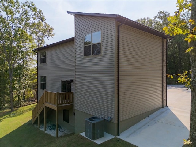 view of home's exterior featuring central AC and a lawn