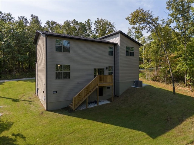 back of house with a yard, stairway, and central air condition unit