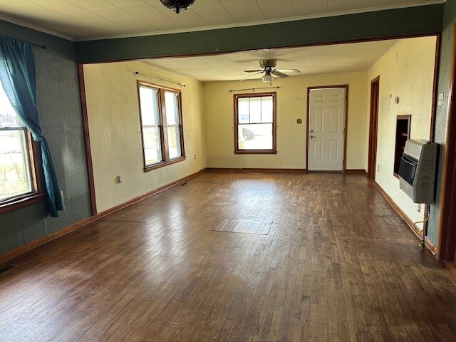 interior space featuring beam ceiling, dark hardwood / wood-style flooring, and ceiling fan