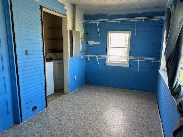 unfurnished bedroom with washer / dryer, a closet, and concrete floors