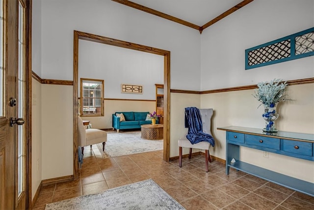 living area with tile patterned flooring and ornamental molding