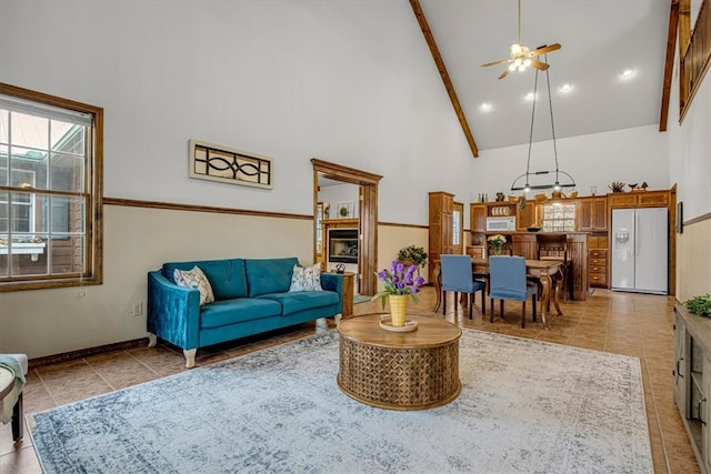 living room featuring beamed ceiling, ceiling fan, light tile patterned floors, and high vaulted ceiling