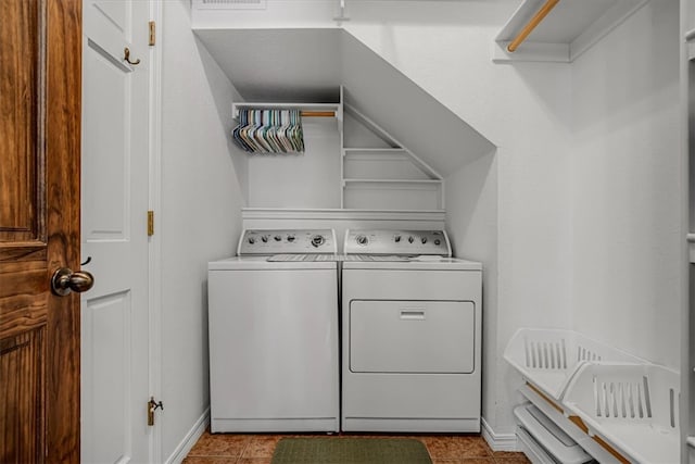 clothes washing area with light tile patterned floors and washing machine and dryer