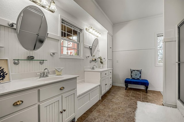 bathroom with vanity, wood walls, and crown molding