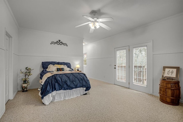 bedroom featuring ceiling fan, wood walls, ornamental molding, and access to outside