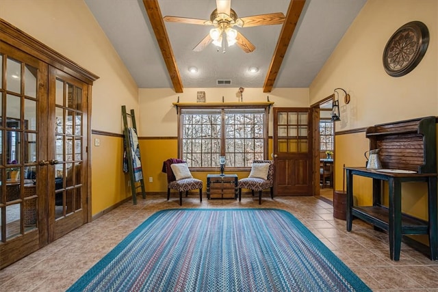 sitting room featuring tile patterned flooring, lofted ceiling with beams, ceiling fan, and french doors