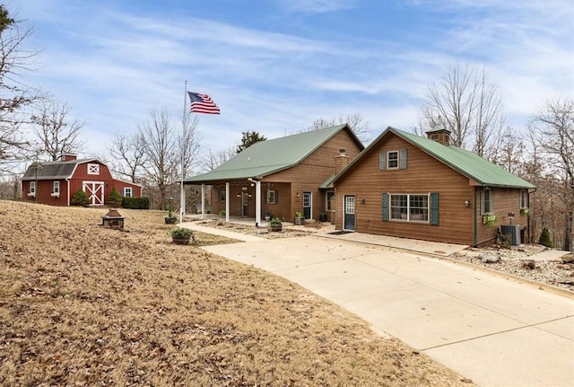 back of property with an outbuilding and cooling unit