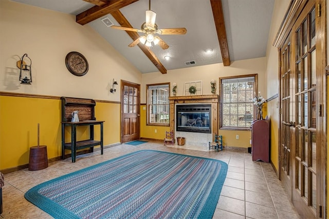 bedroom with tile patterned floors, beamed ceiling, and high vaulted ceiling