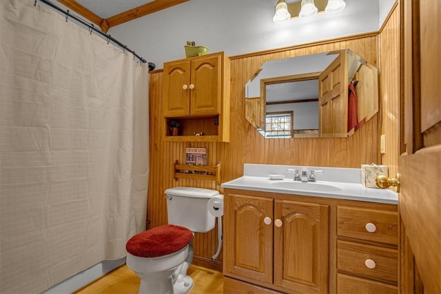 bathroom featuring vanity, crown molding, wooden walls, hardwood / wood-style flooring, and toilet