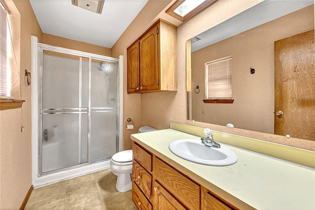 full bathroom with baseboards, a shower stall, toilet, and vanity