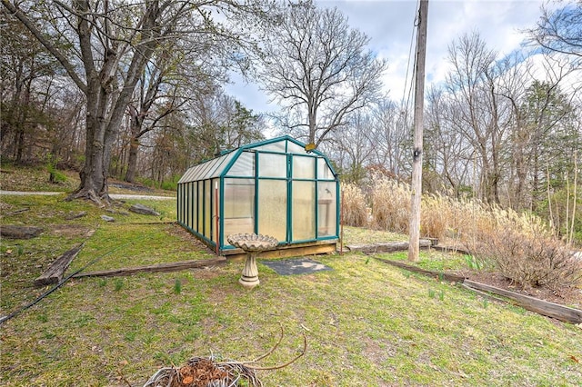 view of greenhouse featuring a lawn