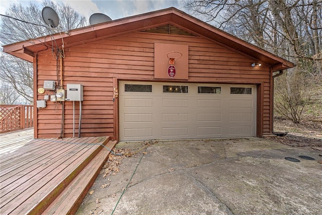 garage featuring concrete driveway