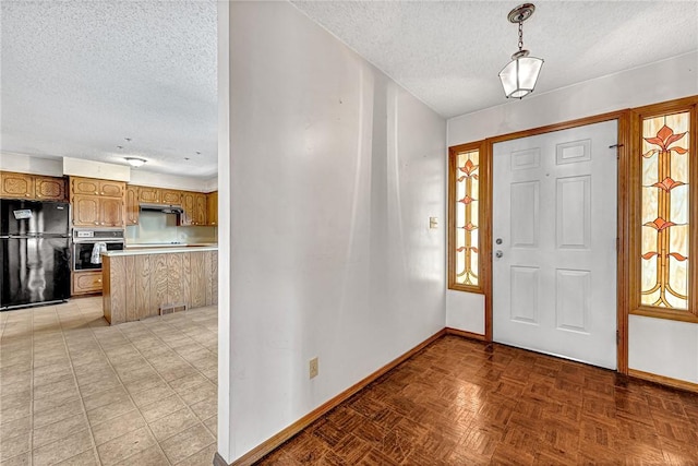 entryway featuring visible vents, a textured ceiling, and baseboards