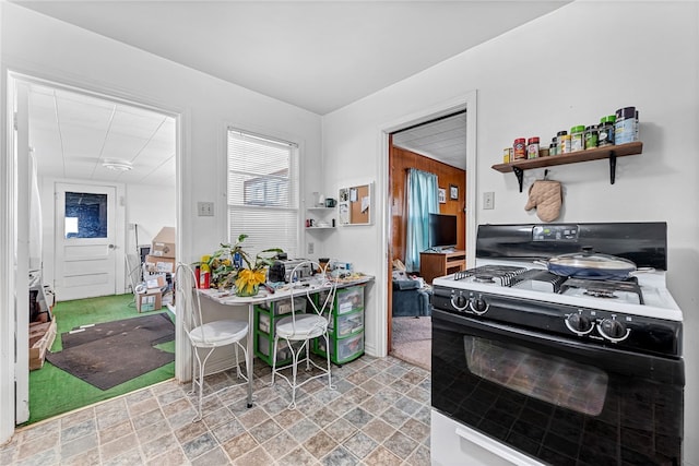 kitchen with light tile flooring and gas range gas stove