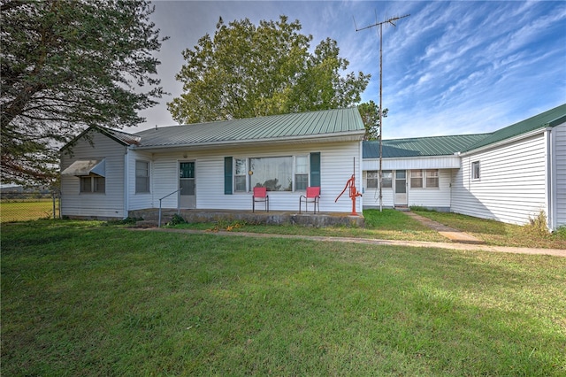 rear view of house with a lawn