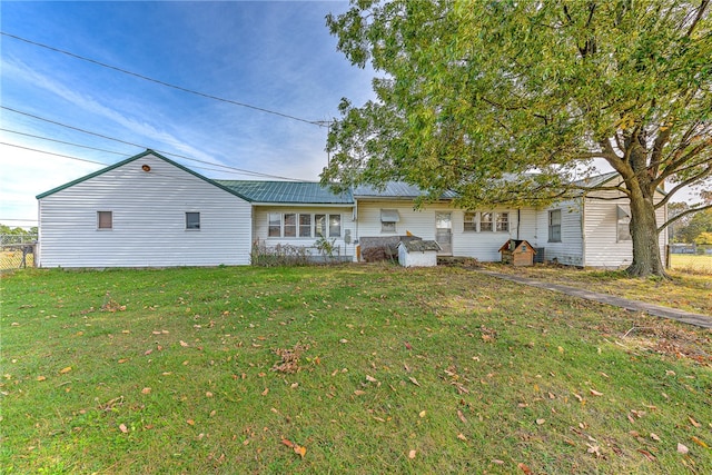 rear view of property with a yard