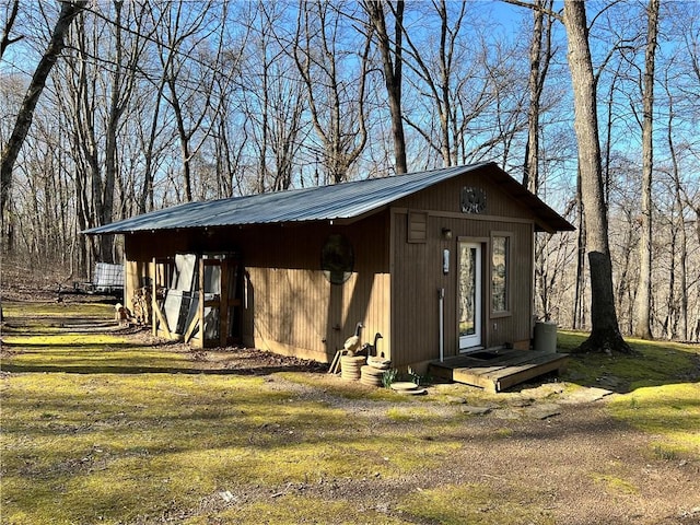 view of outbuilding featuring a yard