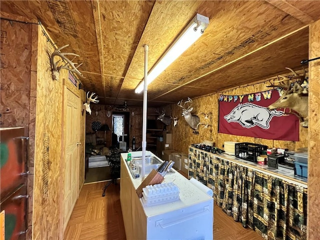 wine area featuring parquet flooring