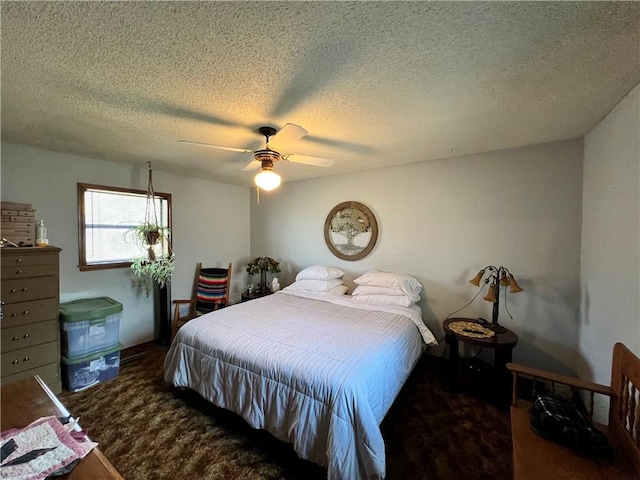 carpeted bedroom featuring ceiling fan and a textured ceiling