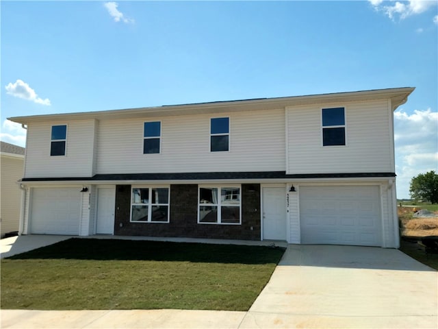 view of front of home with a front lawn and a garage