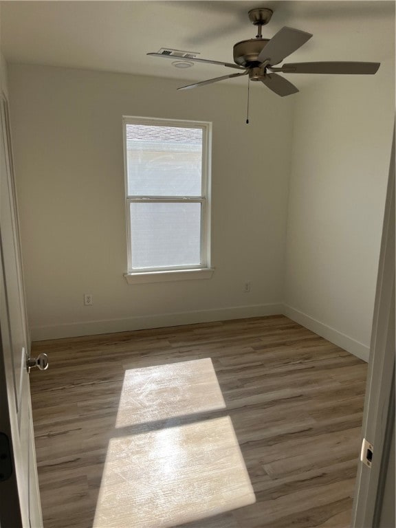 spare room with ceiling fan and light hardwood / wood-style flooring