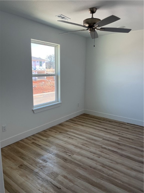 empty room featuring ceiling fan and hardwood / wood-style flooring