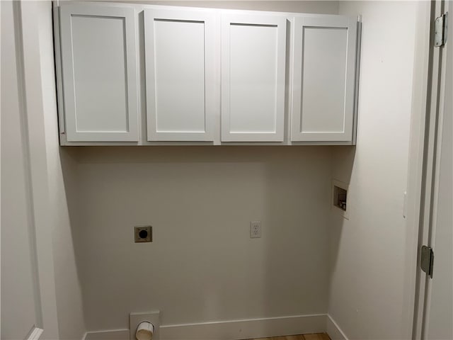 washroom featuring hookup for a washing machine, cabinets, and electric dryer hookup